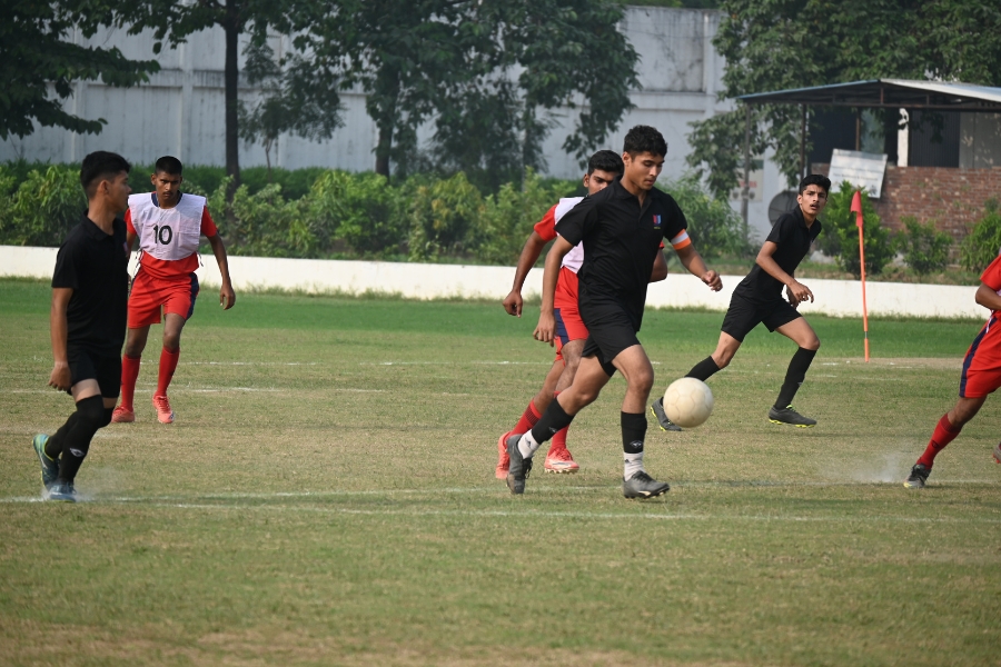 TMU students playing football on the university sports ground